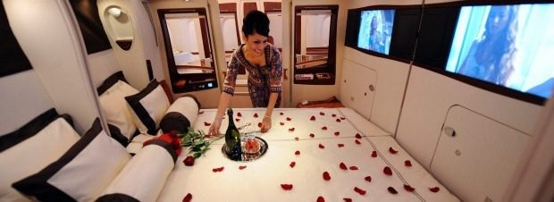 A woman arranging the bed 