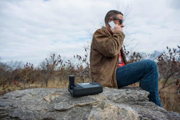 A man using an Iridium Go Sat Phone