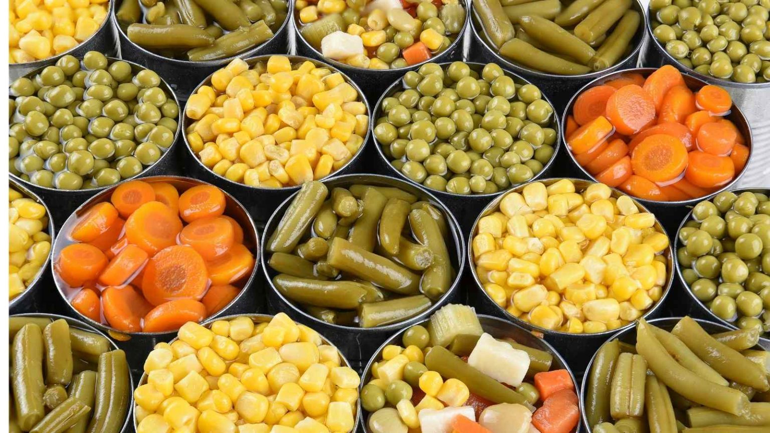 Cheap foods that last a long time Newly-opened cans of canned vegetables including canned beans, carrots, corn, and pickles.