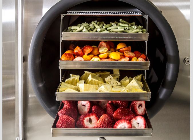How long does freeze dried food last A tray of freeze-dried green beans, tomatoes, pineapples, and strawberries.