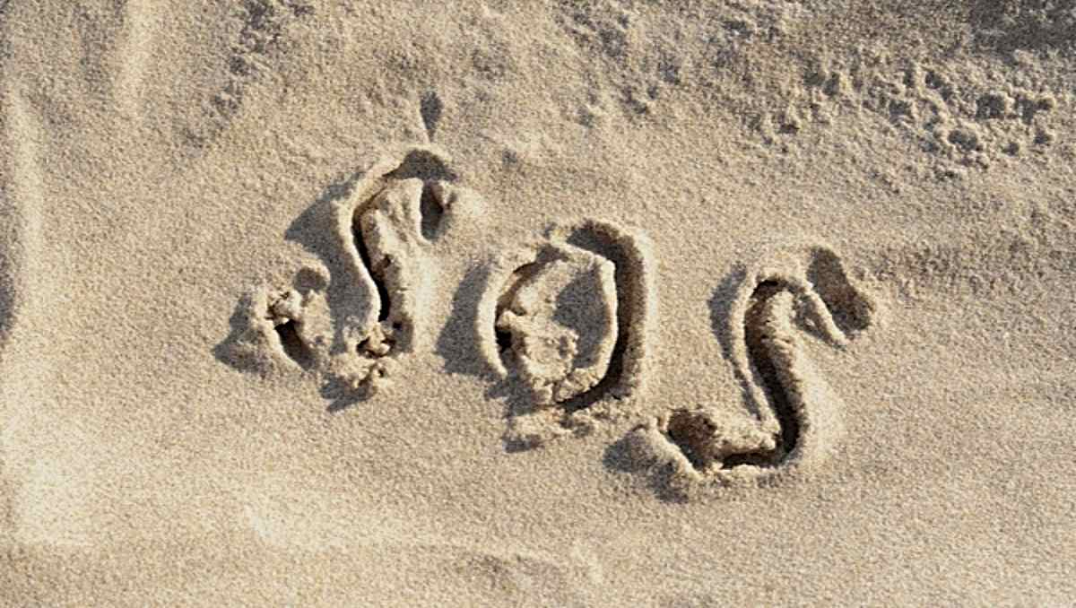 An SOS signal on the sand.